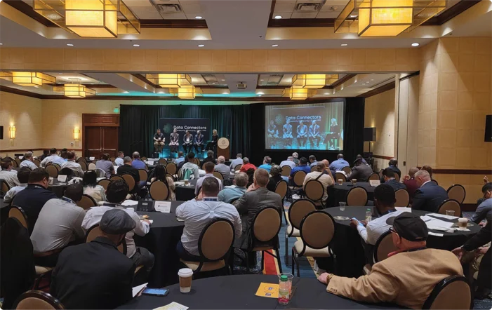 Panelists on stage and attendees at the Data Connectors Cybersecurity Conferences