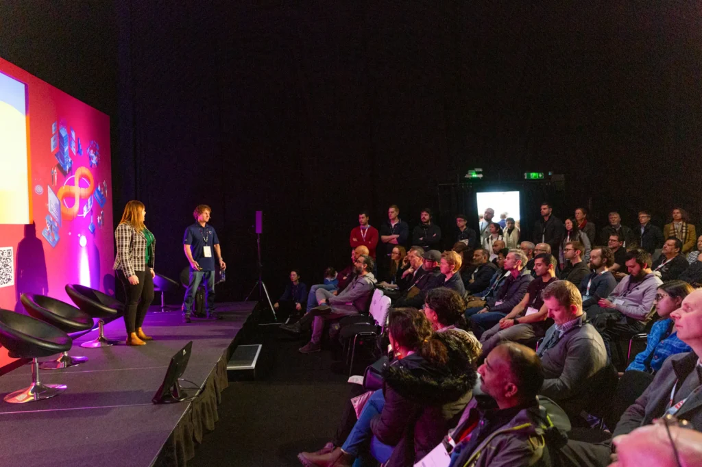 Exhibitors discussing at the DevOps Live conference